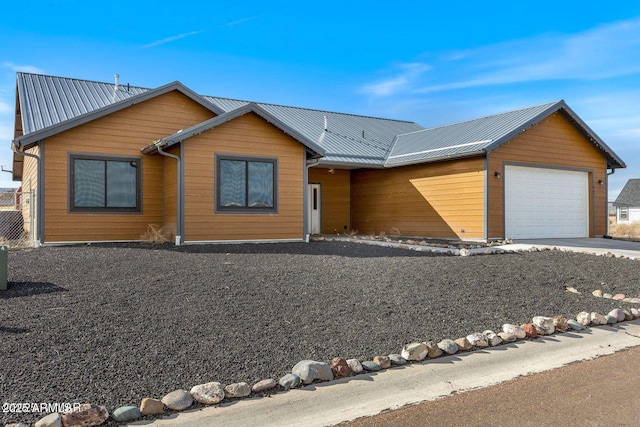 view of front of property featuring a garage and metal roof