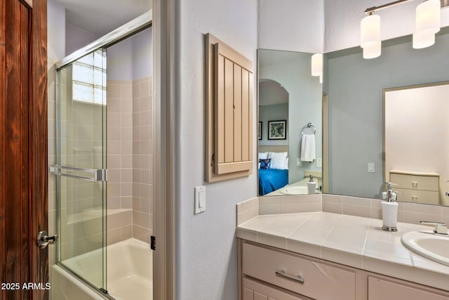 bathroom featuring vanity and bath / shower combo with glass door