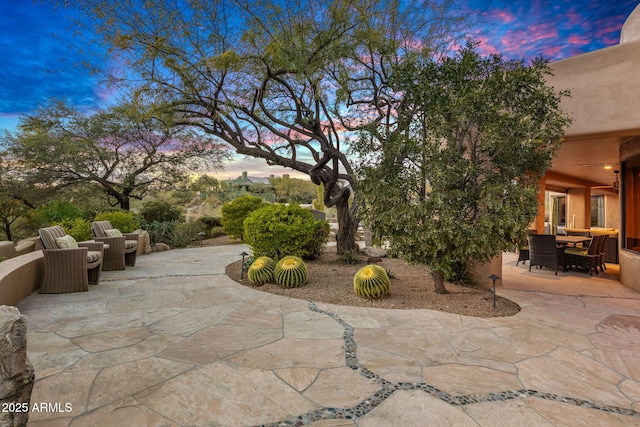 view of patio terrace at dusk