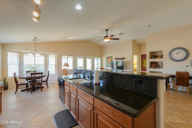 kitchen featuring black dishwasher, lofted ceiling, a wealth of natural light, brown cabinetry, and a sink