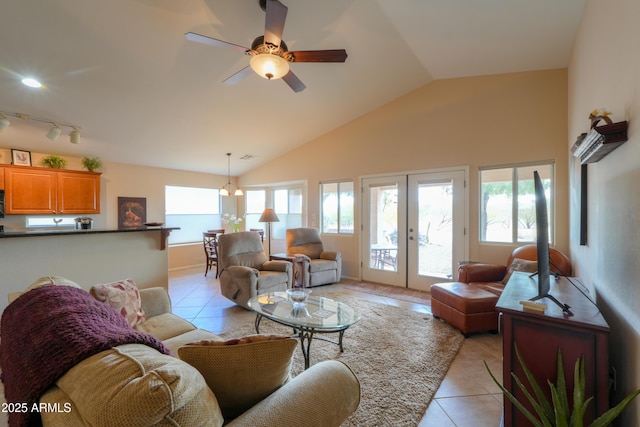 living area with light tile patterned floors, plenty of natural light, vaulted ceiling, and french doors