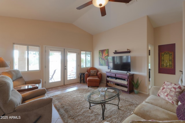 living room with lofted ceiling, ceiling fan, french doors, and light tile patterned flooring