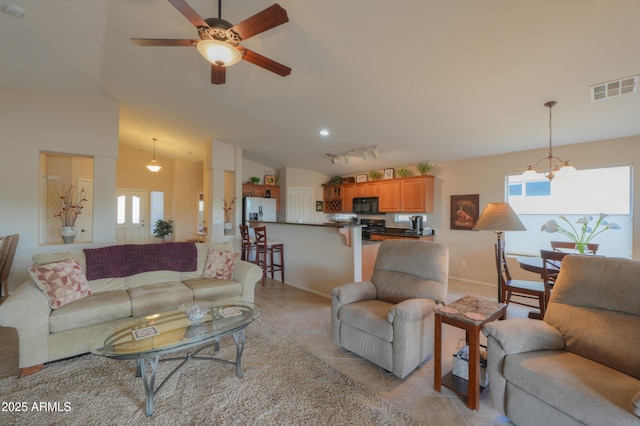 living room with vaulted ceiling, light tile patterned floors, plenty of natural light, and visible vents