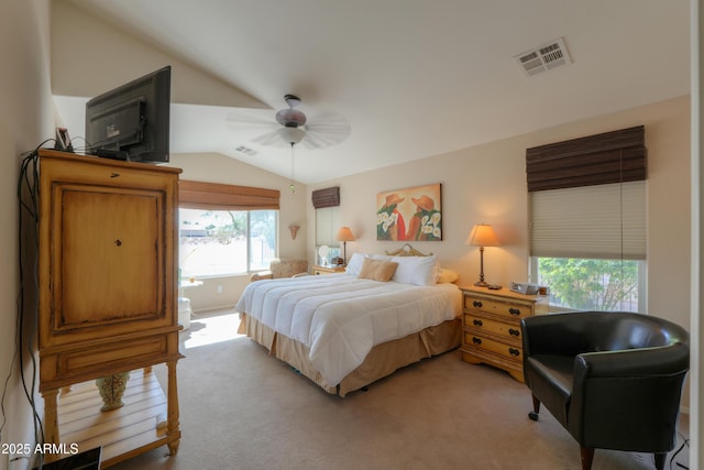 bedroom featuring light colored carpet, visible vents, vaulted ceiling, and ceiling fan