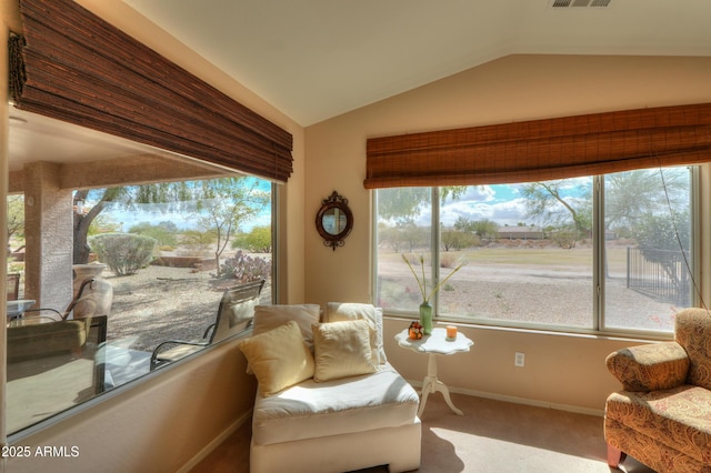 living area with vaulted ceiling, carpet, visible vents, and baseboards