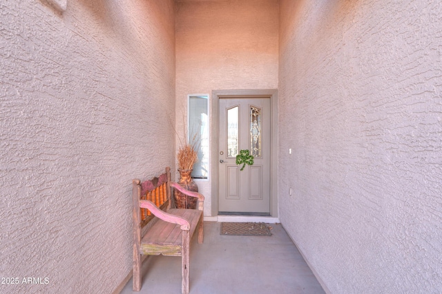 doorway to property featuring stucco siding