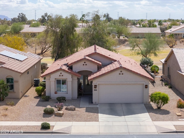 view of front of home with a tile roof, stucco siding, an attached garage, cooling unit, and driveway