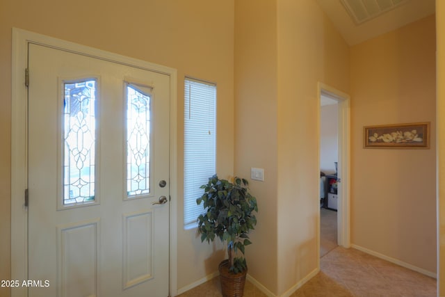 foyer entrance featuring visible vents, baseboards, and light tile patterned flooring