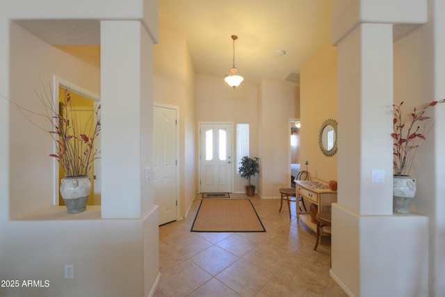 foyer entrance featuring light tile patterned floors and visible vents