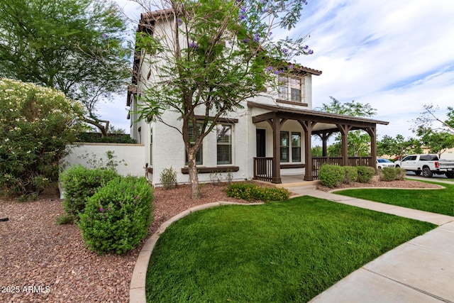 20412 W Thayer St, Buckeye, AZ 85396 - view of front of house with a porch, a front lawn, and stucco siding