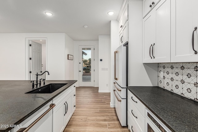 20412 W Thayer St, Buckeye, AZ 85396 - kitchen with a sink, white appliances, light wood finished floors, recessed lighting, and white cabinets