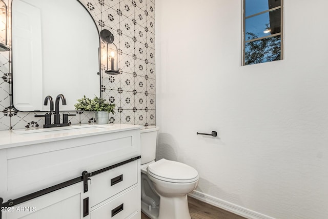 20412 W Thayer St, Buckeye, AZ 85396 - half bath featuring vanity, wood finished floors, toilet, and baseboards