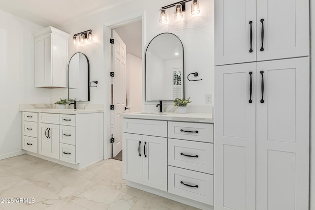 20412 W Thayer St, Buckeye, AZ 85396 - full bathroom with marble finish floors, two vanities, and baseboards