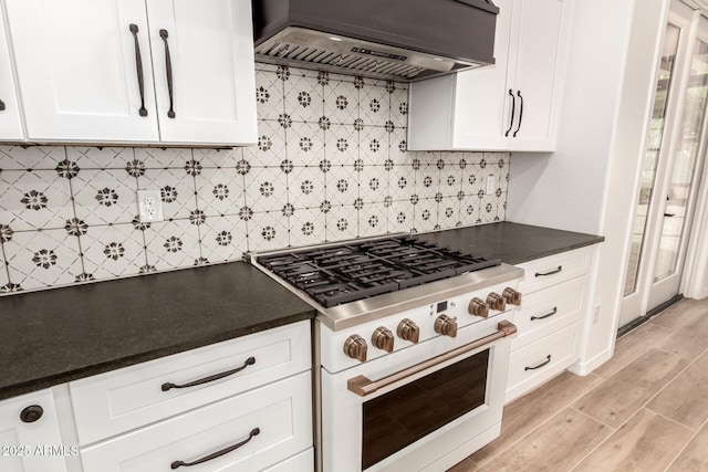 20412 W Thayer St, Buckeye, AZ 85396 - kitchen with range with two ovens, premium range hood, white cabinets, and dark countertops