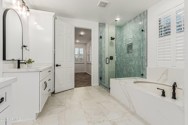 20412 W Thayer St, Buckeye, AZ 85396 - full bath with vanity, a garden tub, a shower stall, marble finish flooring, and baseboards
