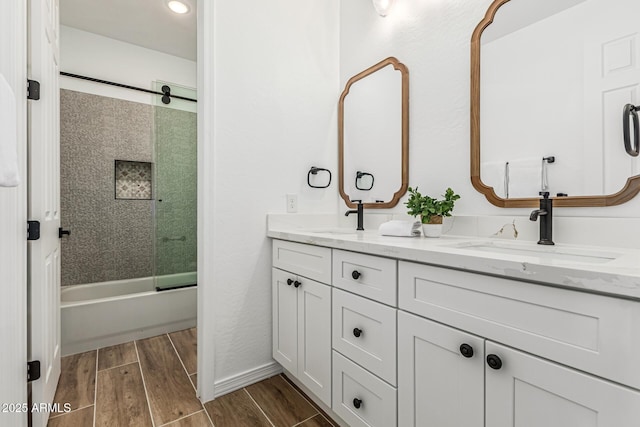 20412 W Thayer St, Buckeye, AZ 85396 - bathroom featuring double vanity, wood finished floors, shower / bath combination with glass door, and recessed lighting