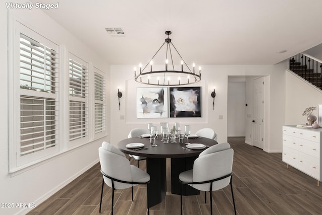 20412 W Thayer St, Buckeye, AZ 85396 - dining area with dark wood finished floors, a chandelier, baseboards, and stairs