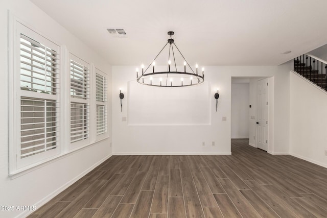 20412 W Thayer St, Buckeye, AZ 85396 - unfurnished dining area with dark wood-type flooring, a chandelier, and baseboards
