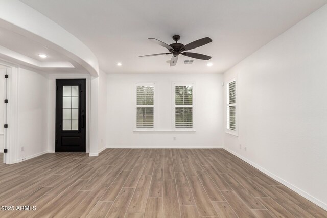 20412 W Thayer St, Buckeye, AZ 85396 - entryway with wood finished floors, baseboards, recessed lighting, ceiling fan, and arched walkways