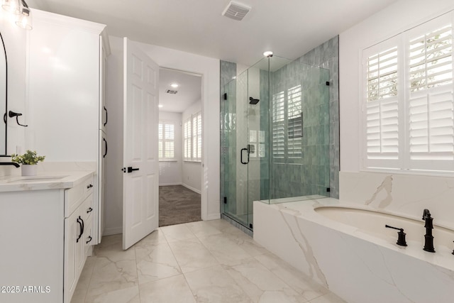 20412 W Thayer St, Buckeye, AZ 85396 - bathroom featuring marble look tile flooring, vanity, a bath, and a stall shower