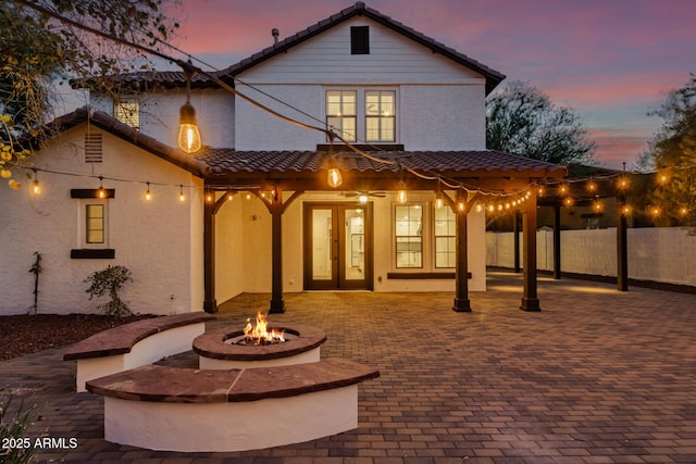 20412 W Thayer St, Buckeye, AZ 85396 - rear view of property with an outdoor fire pit, a tiled roof, and stucco siding