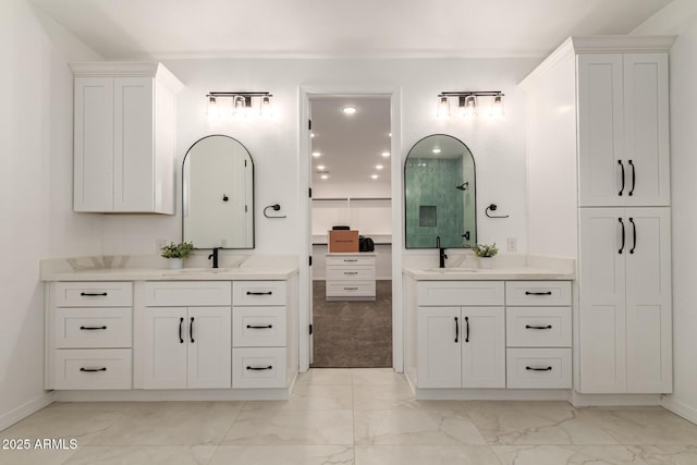 20412 W Thayer St, Buckeye, AZ 85396 - bathroom with marble finish flooring, two vanities, a shower, and baseboards