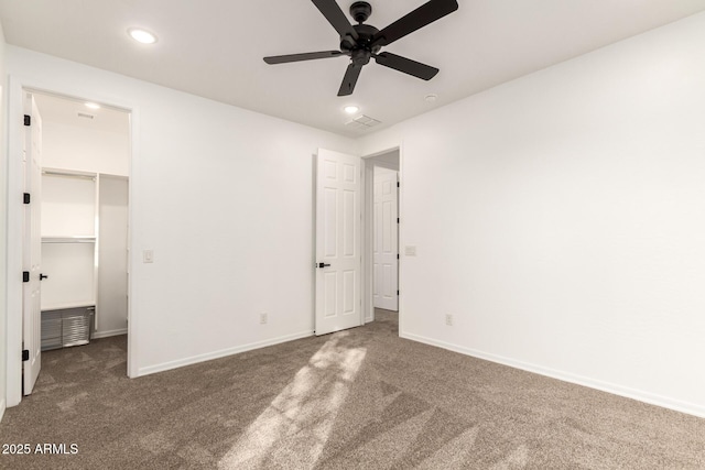 20412 W Thayer St, Buckeye, AZ 85396 - unfurnished bedroom with carpet floors, recessed lighting, a walk in closet, baseboards, and a ceiling fan