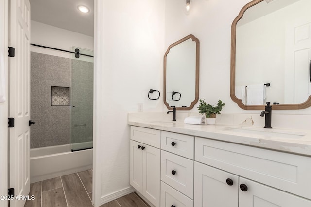 20412 W Thayer St, Buckeye, AZ 85396 - full bath with double vanity, shower / bath combination with glass door, wood finished floors, and recessed lighting