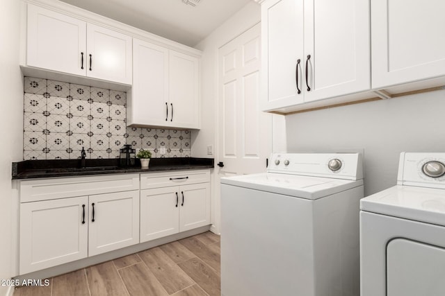 20412 W Thayer St, Buckeye, AZ 85396 - washroom featuring washer and dryer, light wood-style floors, and cabinet space