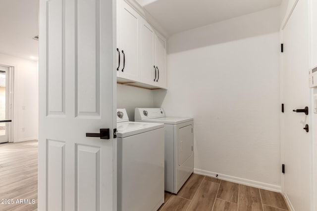 20412 W Thayer St, Buckeye, AZ 85396 - laundry room featuring cabinet space, independent washer and dryer, light wood-style floors, and baseboards