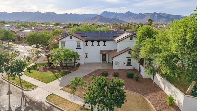 20412 W Thayer St, Buckeye, AZ 85396 - view of front of house with solar panels, a residential view, driveway, stucco siding, and a mountain view