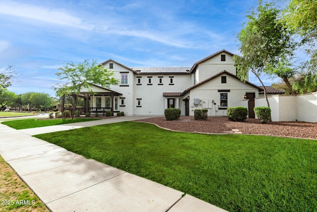 20412 W Thayer St, Buckeye, AZ 85396 - view of front facade with a gazebo, a front lawn, roof mounted solar panels, stucco siding, and a tile roof