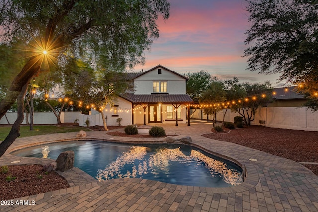 20412 W Thayer St, Buckeye, AZ 85396 - pool at dusk with a patio and a fenced backyard