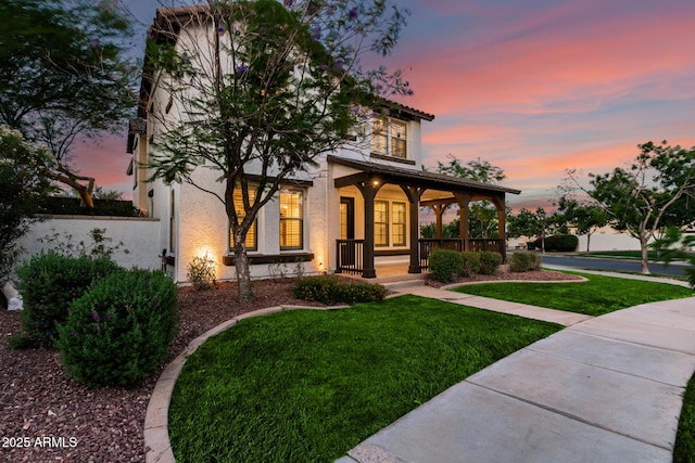 20412 W Thayer St, Buckeye, AZ 85396 - view of front of home featuring covered porch, a yard, and stucco siding