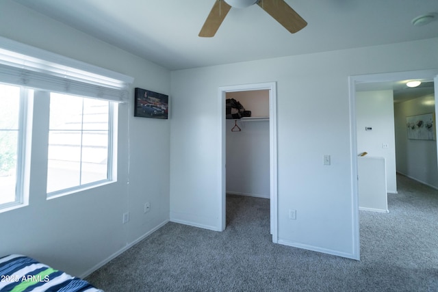 12161 W Flanagan St, Avondale, AZ 85323 - unfurnished bedroom with carpet flooring, a spacious closet, a closet, and a ceiling fan