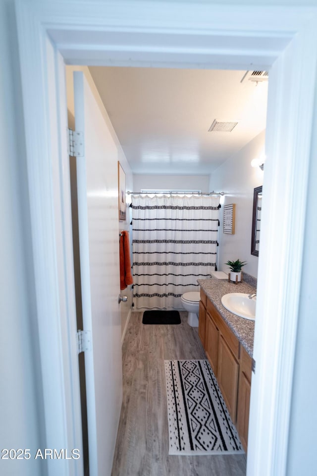 12161 W Flanagan St, Avondale, AZ 85323 - bathroom featuring vanity, wood finished floors, and curtained shower