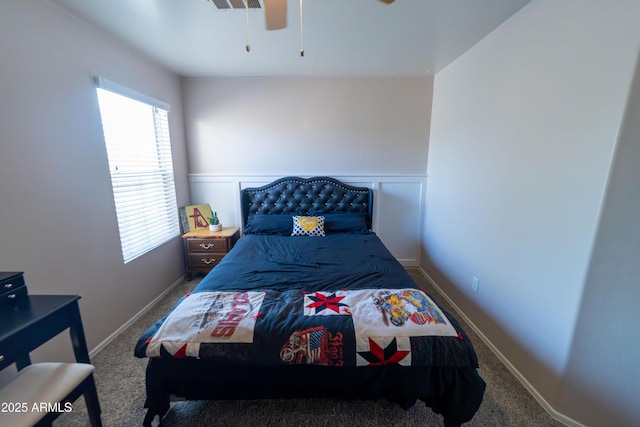 12161 W Flanagan St, Avondale, AZ 85323 - bedroom with multiple windows, carpet floors, a wainscoted wall, and ceiling fan
