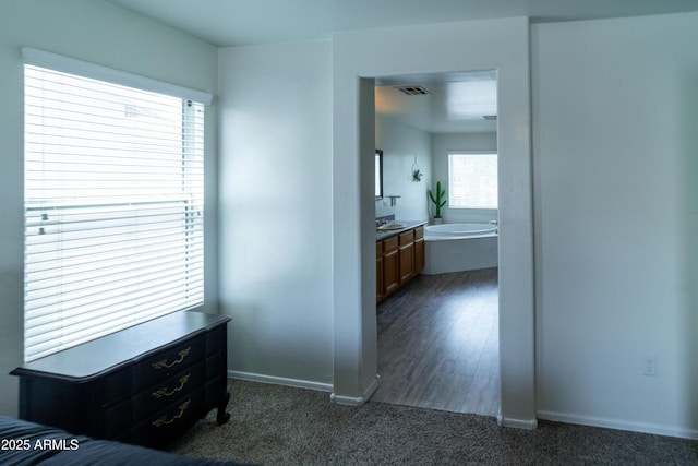 12161 W Flanagan St, Avondale, AZ 85323 - corridor featuring baseboards and dark colored carpet