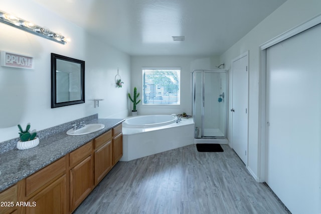 12161 W Flanagan St, Avondale, AZ 85323 - bathroom featuring vanity, wood finished floors, a stall shower, and a garden tub