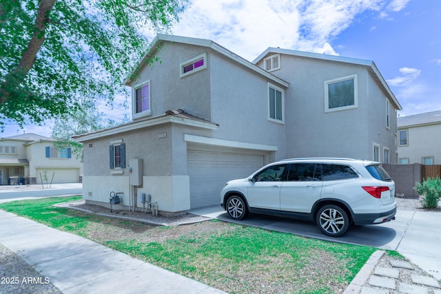 12161 W Flanagan St, Avondale, AZ 85323 - view of side of property with stucco siding, an attached garage, and concrete driveway