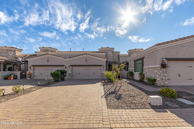 mediterranean / spanish-style home with a garage