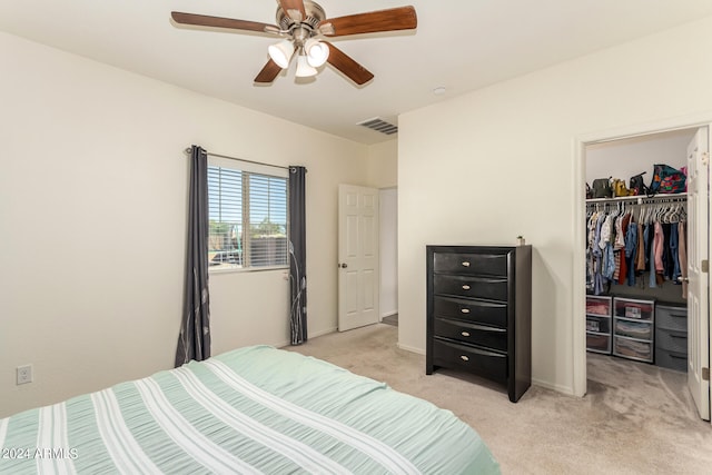 carpeted bedroom with a closet and ceiling fan