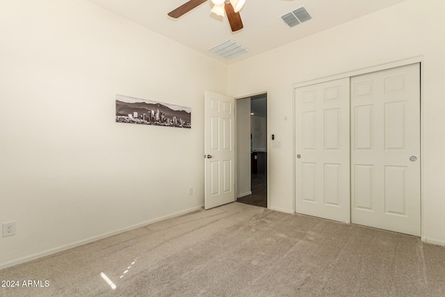 unfurnished bedroom featuring a closet, carpet floors, and ceiling fan