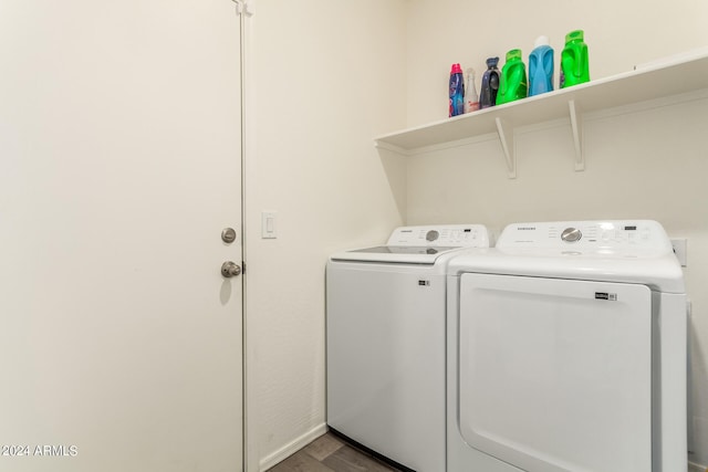 washroom featuring hardwood / wood-style flooring and washing machine and clothes dryer