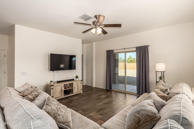 living room featuring dark wood-type flooring and ceiling fan