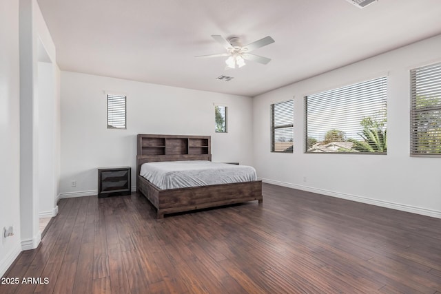 bedroom featuring dark wood-type flooring, visible vents, baseboards, and multiple windows