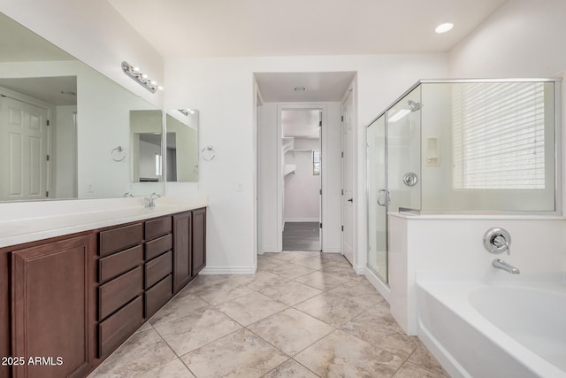 full bathroom featuring baseboards, a spacious closet, vanity, a shower stall, and a bath