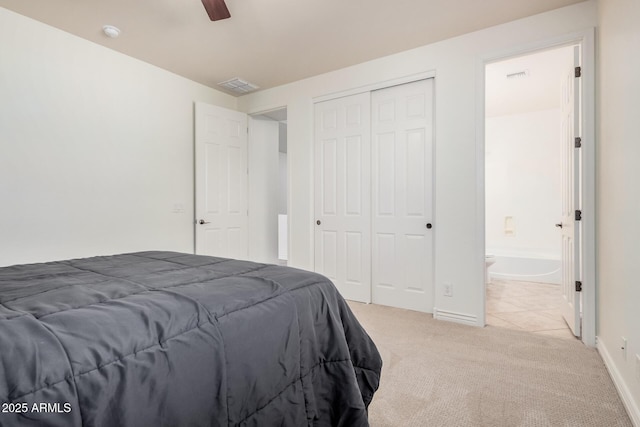 bedroom with light colored carpet, a closet, visible vents, and baseboards