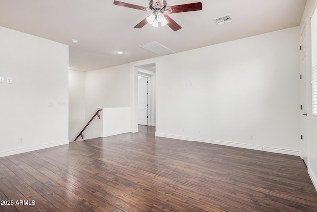 empty room with a ceiling fan, visible vents, baseboards, and wood finished floors