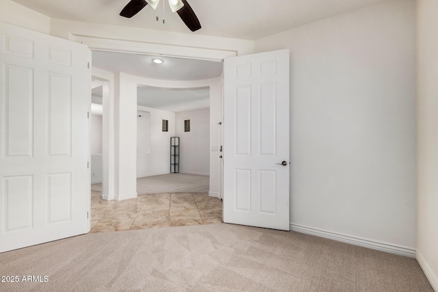 unfurnished room with ceiling fan, carpet, and baseboards